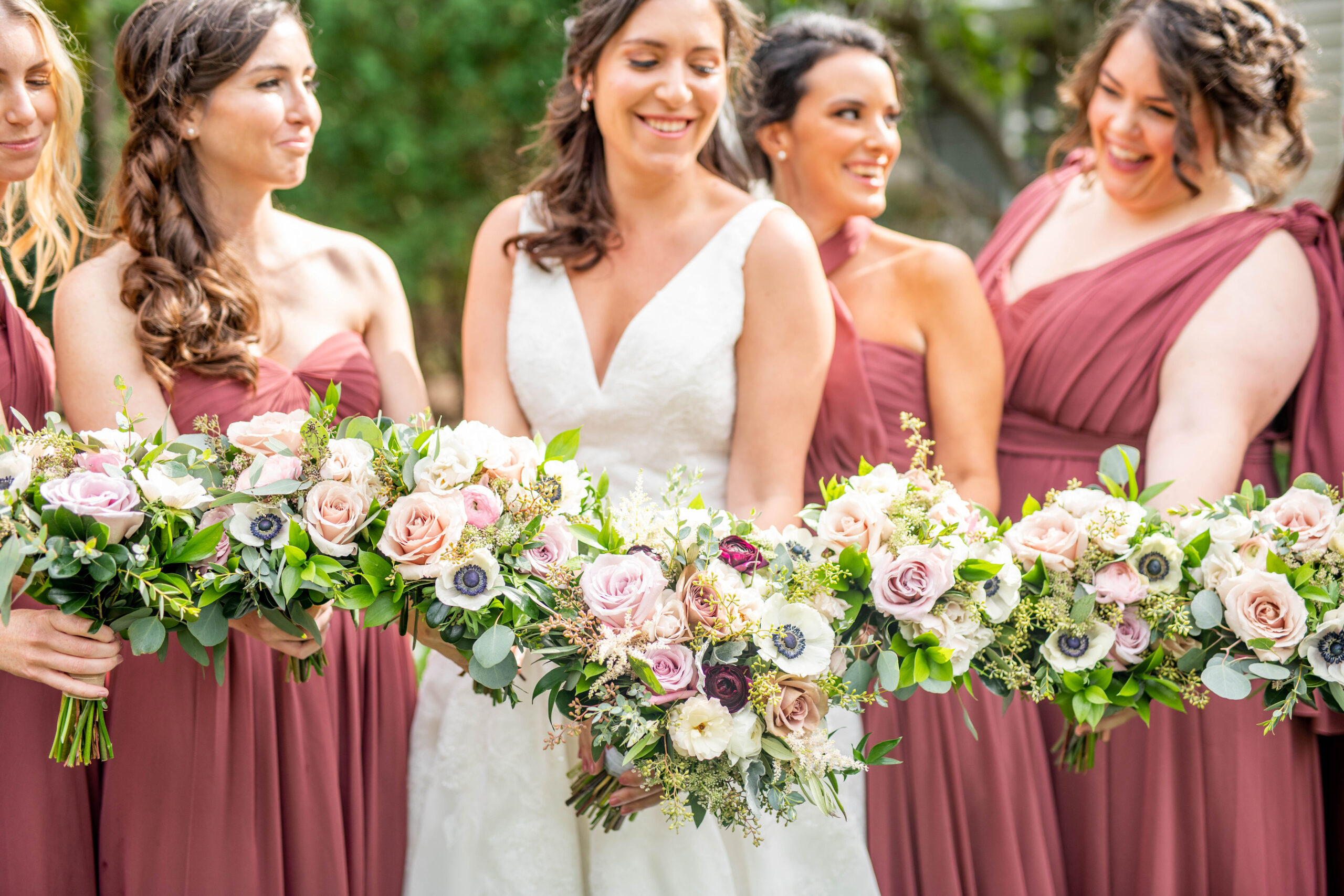 bridal party holding elegant wedding bouquets